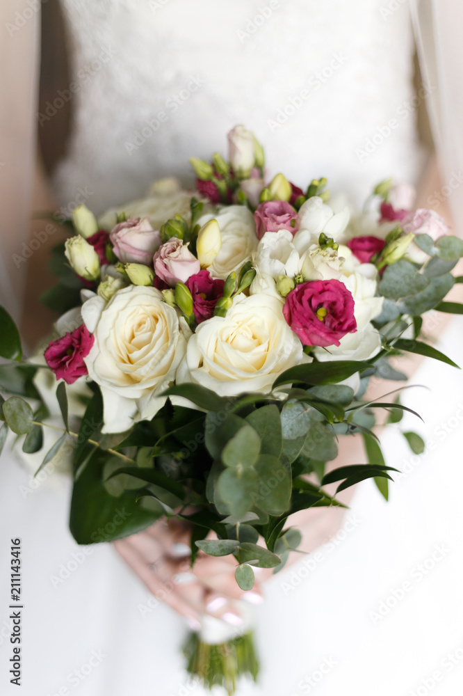 Wedding bouquet in hands of the bride Wedding bouquet in hands of the bride