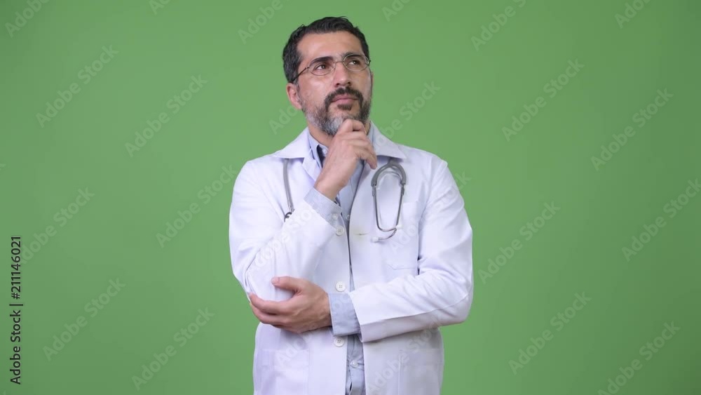 Handsome Persian bearded man doctor thinking Handsome Persian bearded man doctor thinking