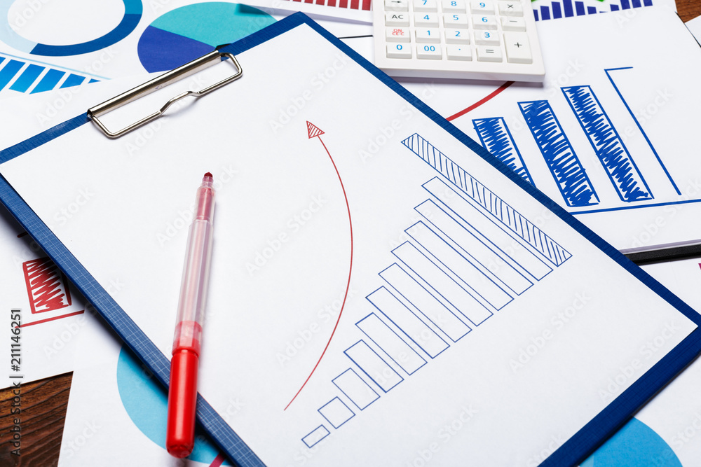 Top view of business paper chart or graph on wooden table Top view of business paper chart or graph on wooden table