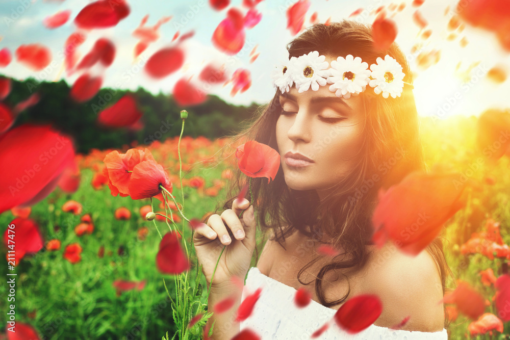 Beautiful woman in field with a lot of poppy flowers