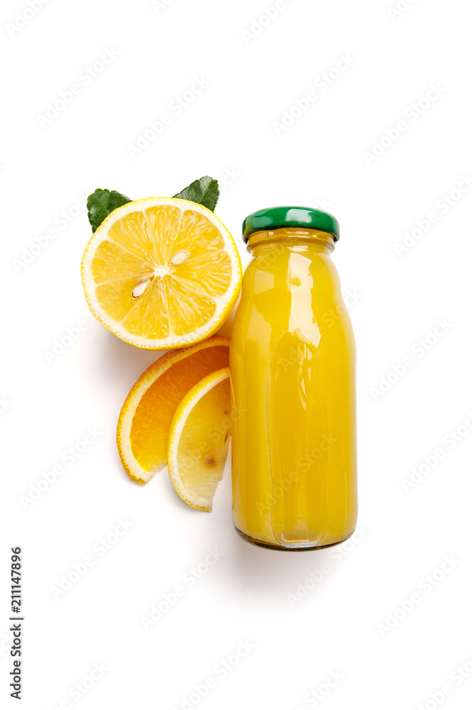Citrus fresh squeezed juice in a small glass bottle and fresh lemon on a clean white background close-up. Citrus fresh squeezed juice in a small glass bottle and fresh lemon on a clean white background close-up.