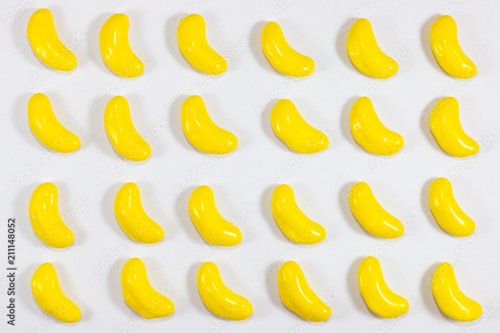 yellow color sweet banana shape . sugar yummy candy on white background . 