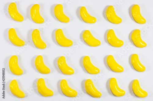 yellow color sweet banana shape . sugar yummy candy on white background . 