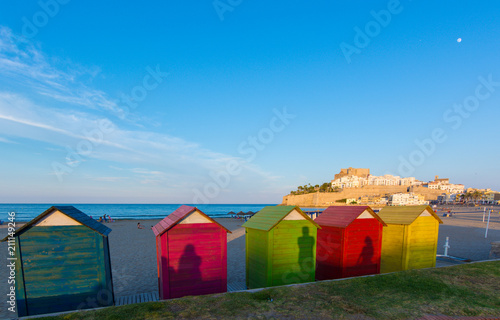 Colorful beach huts on Peniscola beach © tanaonte