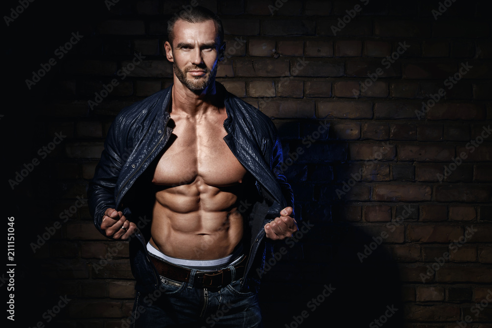 Handsome bodybuilder showing his muscular body Stock Photo | Adobe Stock