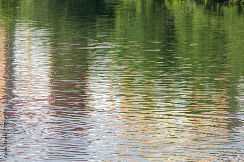 Reflection of a brick building on the lake as an abstract background