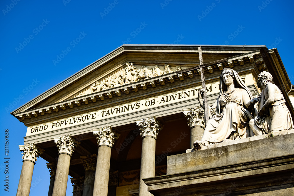 Fototapeta premium View from below of the sculpture that presides over the Catholic Parish Church Gran Madre Di Dio located on the other side of the river in the center of the city. Photograph taken in Turin, Italy.