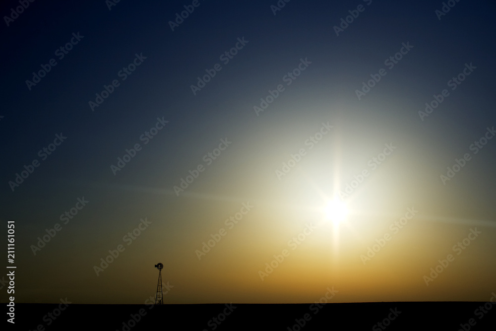 Lone windmill looking into the sun