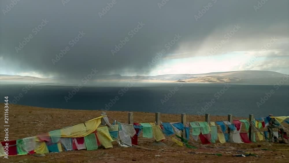 Storm Cloud and Prayer Flags over Lake, Tibet Storm Cloud and Prayer Flags over Lake, Tibet