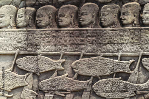 фотографія Ancient temple stone carved bas-relief in Angkor Wat
