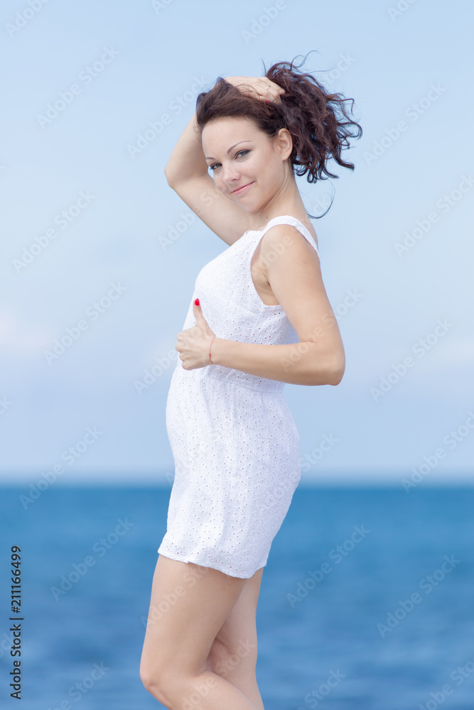 Girl collects her hair in ponytail and shows thumb up