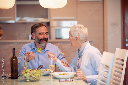 Mature couple having lunch at home