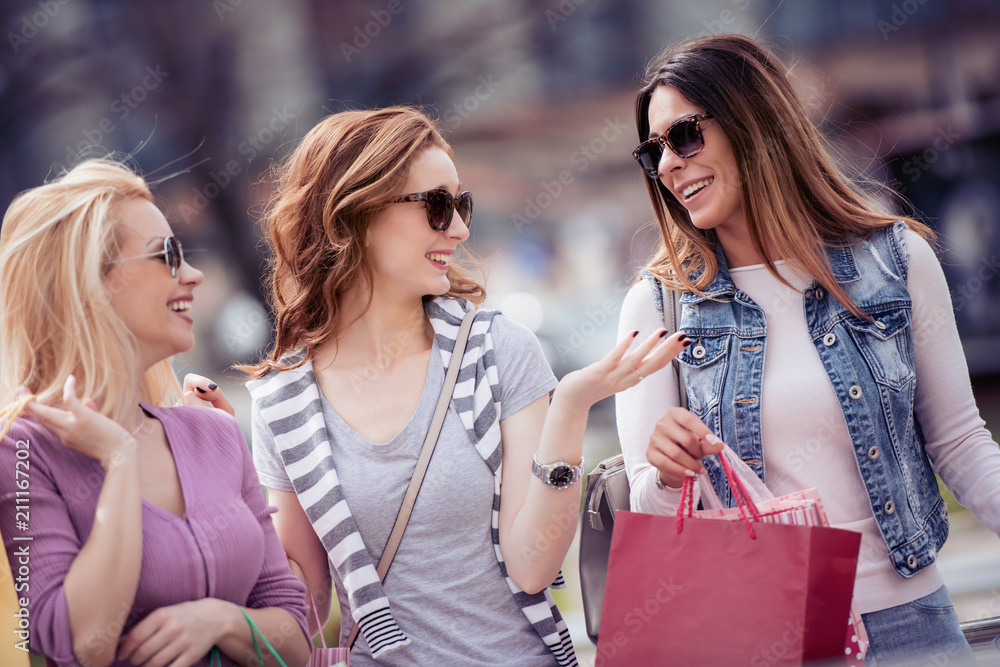 Cheerful girls with shopping bags in the city Cheerful girls with shopping bags in the city