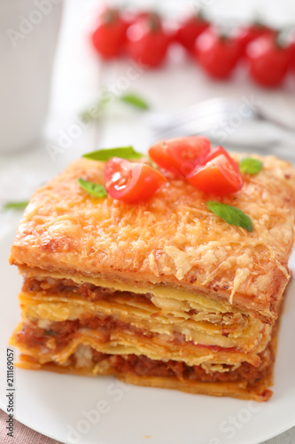 Plate with tasty lasagna on table, closeup