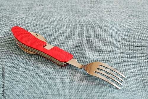 Set of knife, fork and travel spoon with red grip photo