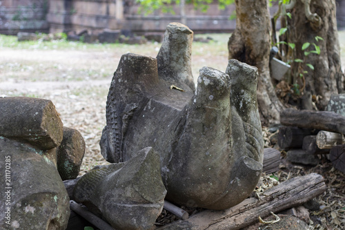 Ancient stone ruin in Angkor Wat temple. Animal stone statue ruin on ground. Khmer heritage temple ruin in jungle.