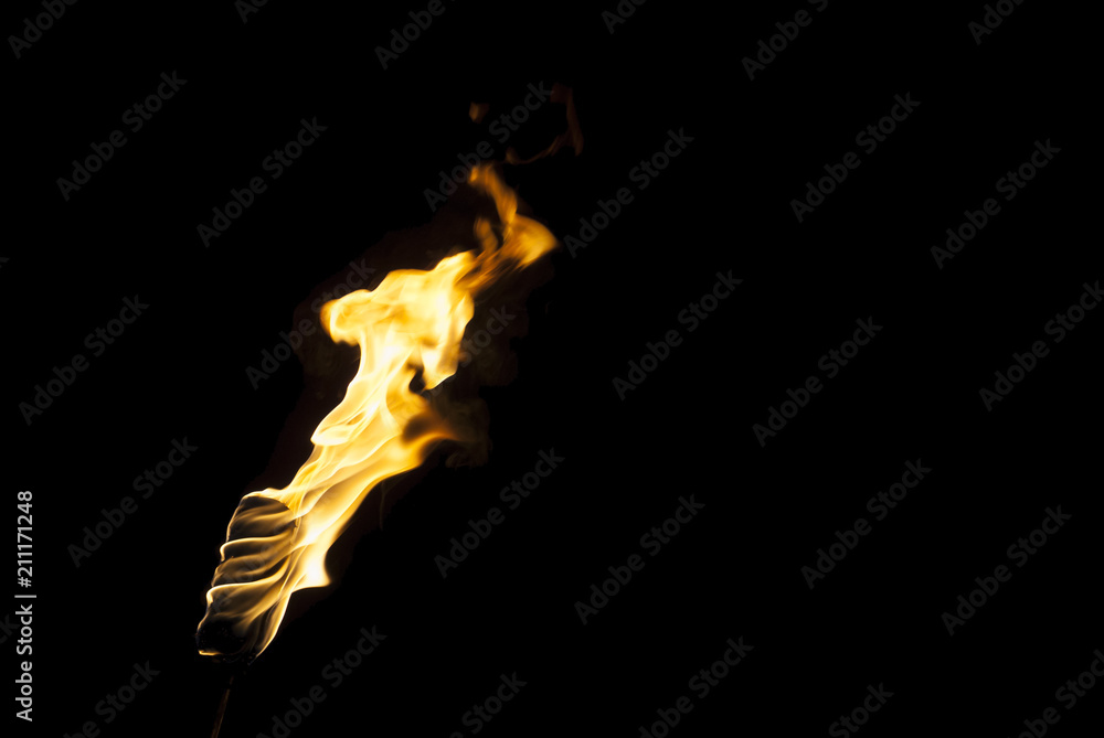 flame of a torch in the dark on a black background, only the fire is visible