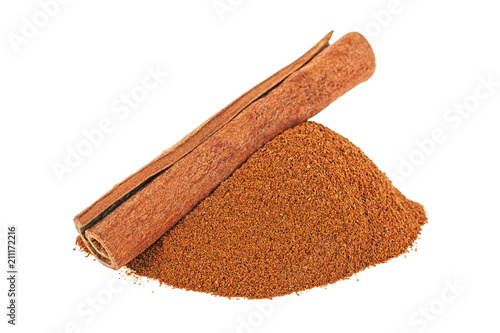 Single cinnamon stick and cinnamon powder on white background