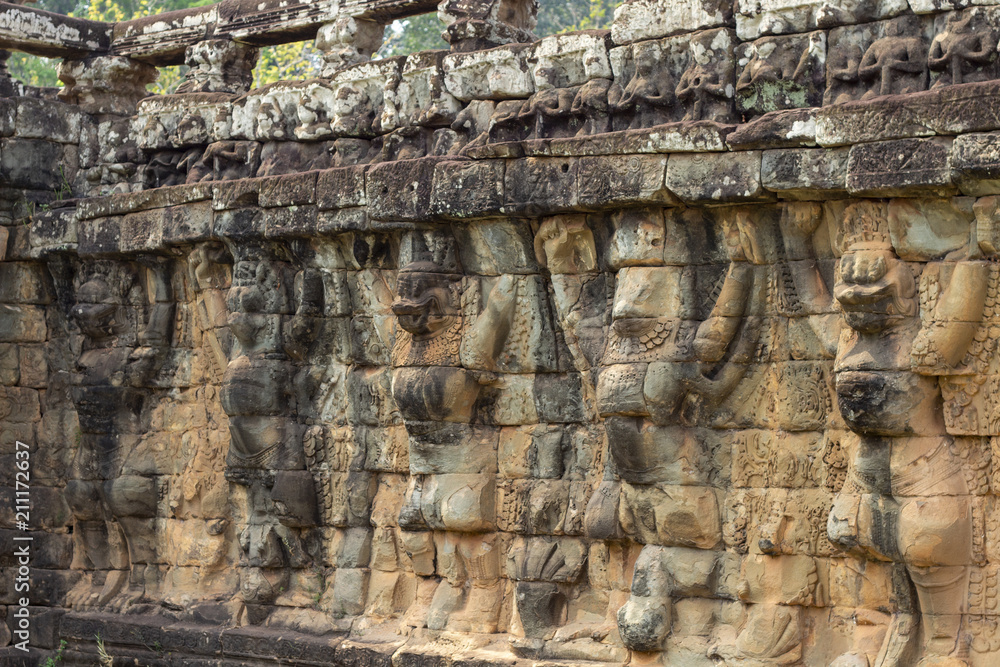 Ancient temple stone carved bas-relief in Angkor Wat. Human-like animals bas-relief closeup.