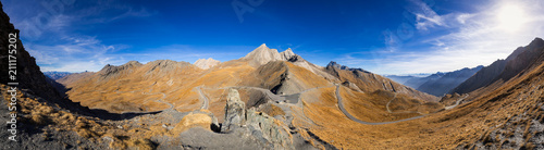 Panoramic view on Col Agnel in Hautes-Alpes in Fall. In the center, the mountain peak Pain de Sucre, separating France and Italy. Queyras Regional Natural Park, France