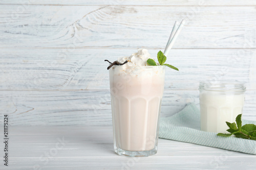 Glassware with delicious milk shakes on table