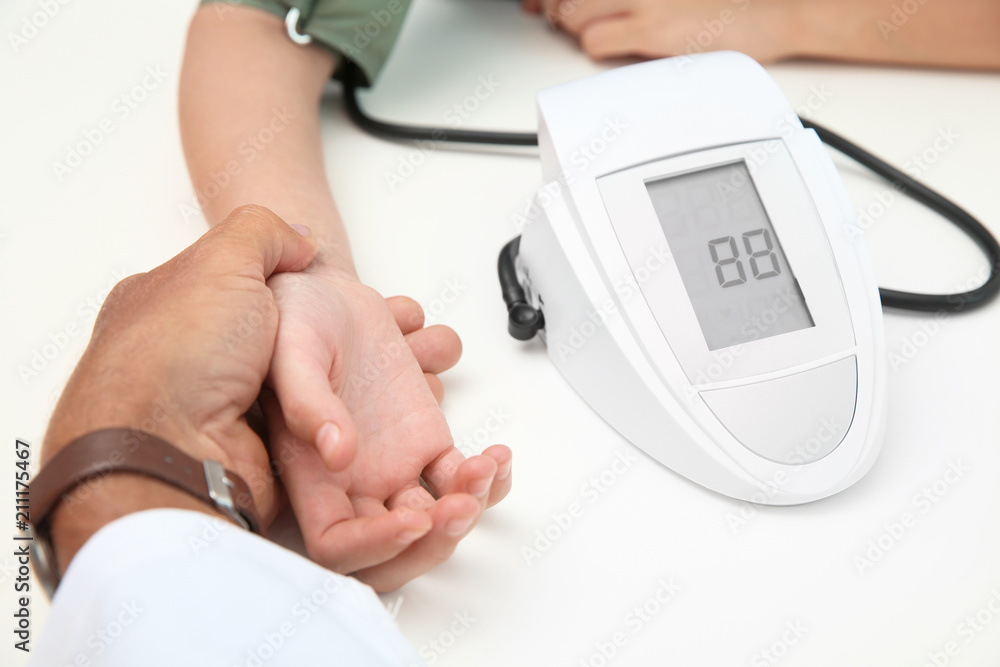 Doctor checking little girl's pulse in hospital Doctor checking little girl's pulse in hospital