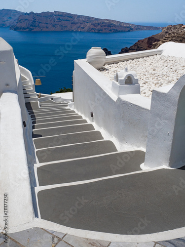 Steps and white architecture on Santorini island, Greece. Beautiful summer landscape, sea view.