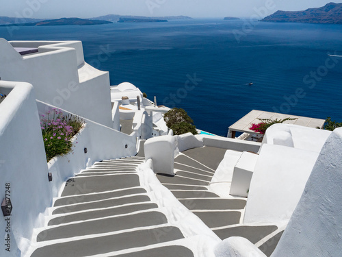 Steps and white architecture on Santorini island, Greece. Beautiful summer landscape, sea view.