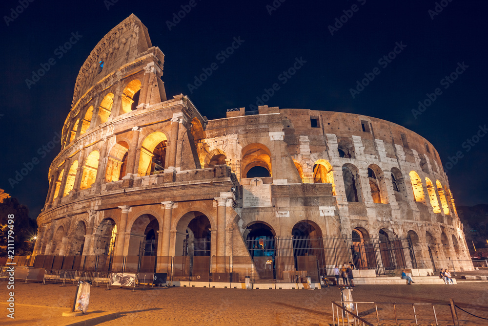 Roman Colosseum (Coliseum) at night, one of the main travel attractions in Rome. Italy