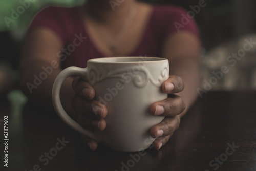 Female Hands Holding A White Cup 