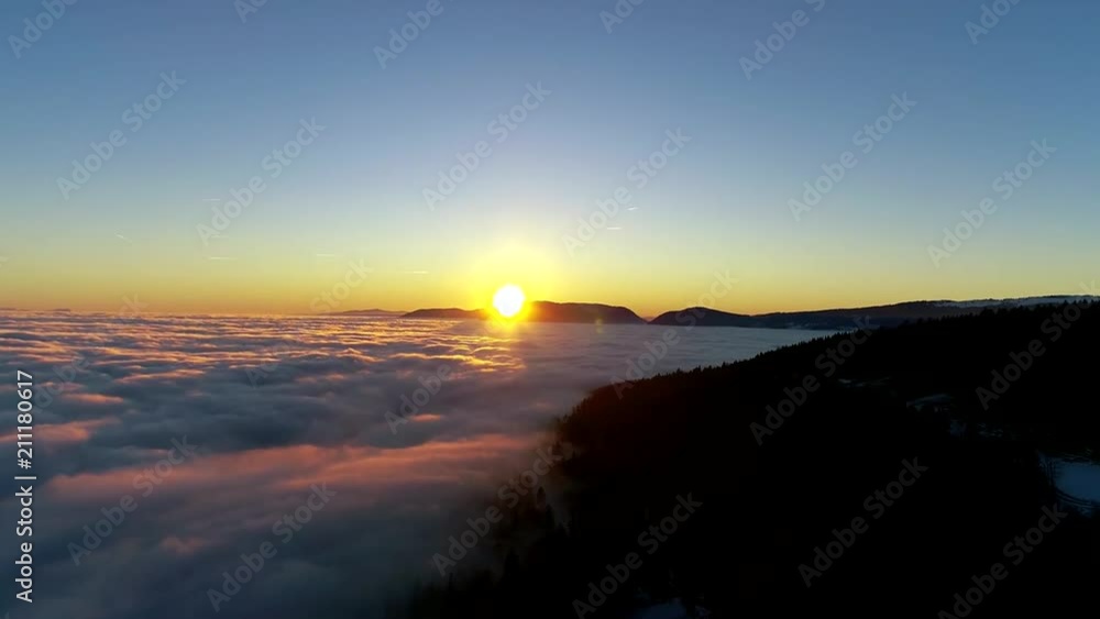 Beautiful 4k aerial drone flight over sunset sky full of white fluffy clouds in warm orange evening sun light Beautiful 4k aerial drone flight over sunset sky full of white fluffy clouds in warm orange evening sun light