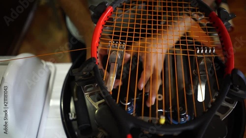 Stringing a tennis racket in slow motion photo