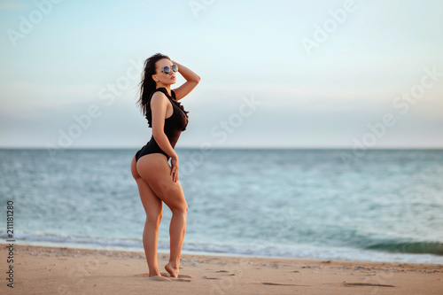The beautiful bikini model on sunset
