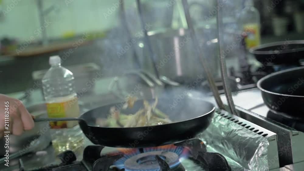 Close up of working chef preparing chinese or mexican food, Food frying in wok pan. Sale and food concept Close up of working chef preparing chinese or mexican food, Food frying in wok pan. Sale and food concept