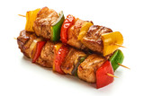 Skewers with pieces of grilled barbecue, red, yellow and green bell pepper, seasoned with coarse salt and olive oil, isolated on white background. Close-up.