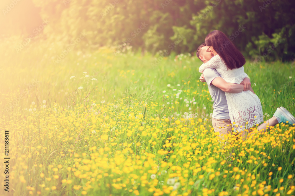 Couple standing and embracing in the yellow meadow Couple standing and embracing in the yellow meadow