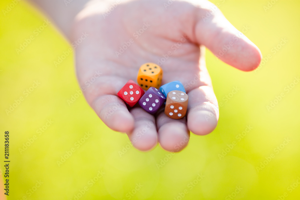 Mixed color dice at adult man hand Mixed color dice at adult man hand