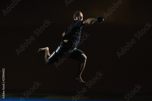 A man in jump a punch beats his fist © andreyfire