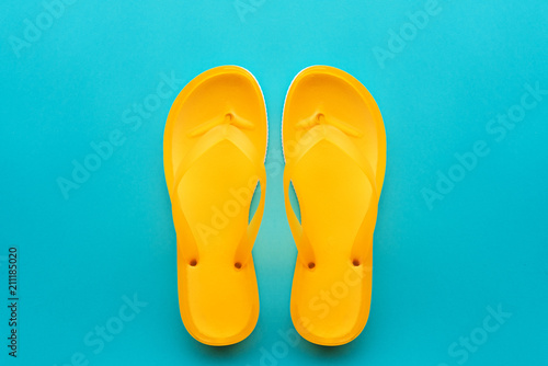 Yellow flip flops on blue background