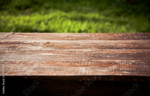 wooden picnic tabletop in the garden - summertime background with copy space