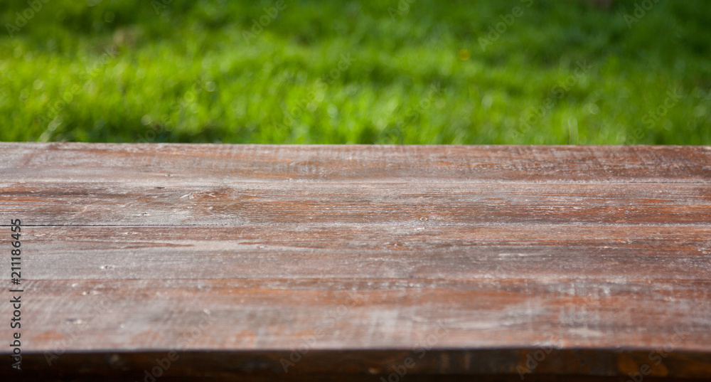 wooden picnic tabletop in the garden - summertime background with copy space wooden picnic tabletop in the garden - summertime background with copy space
