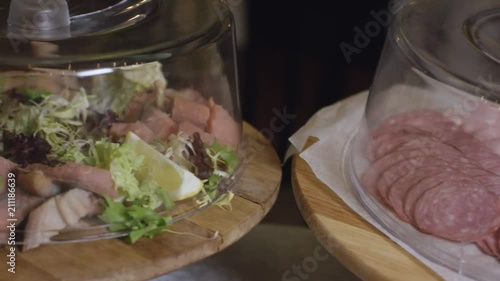 slicing sausages on buffet at the new hotel