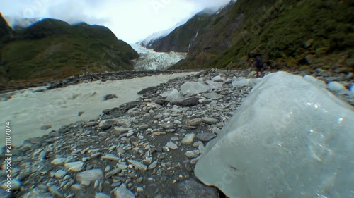 Massive Glacial Ice Chunk with a Roiling Creek behind It photo