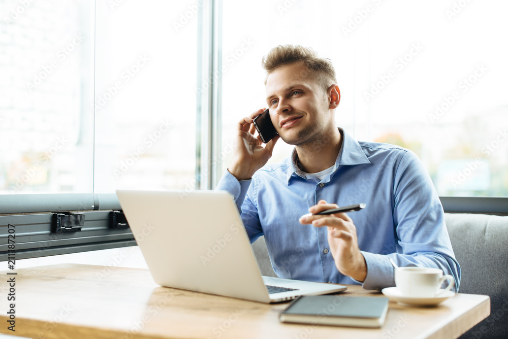 Stylish young man calling by the phone to solve business problems. Online consultation by phone. Freelancer discussing the development and planning of his online project. Outsourcing. Mobile services. Stylish young man calling by the phone to solve business problems. Online consultation by phone. Freelancer discussing the development and planning of his online project. Outsourcing. Mobile services.