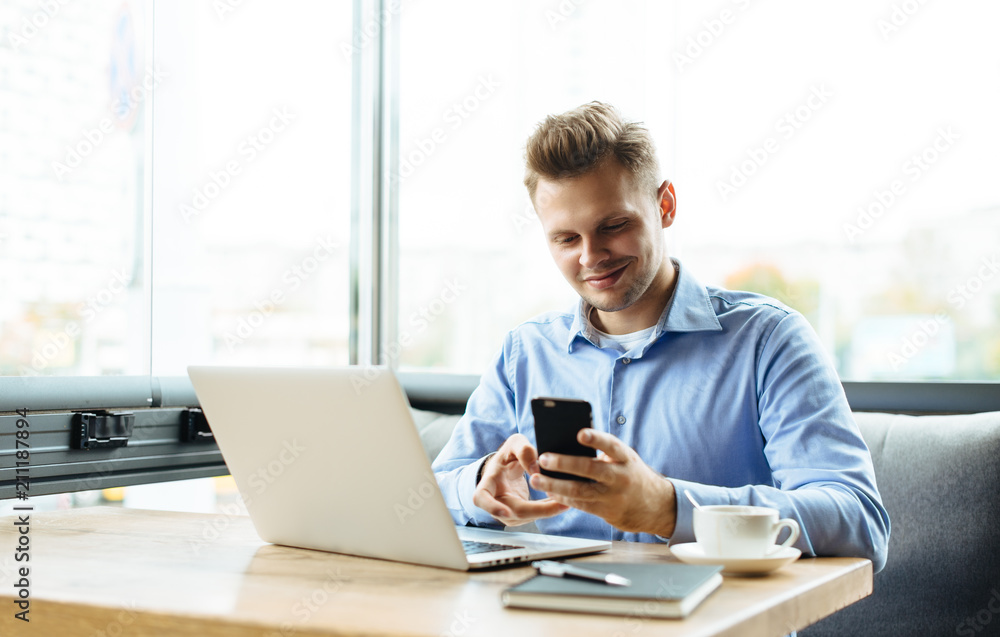 Young man drawing template for the web site associated with digital marketing, current trends and tendencies of UX / UI design. Businessman who rules his company remotely, like a freelancer Young man drawing template for the web site associated with digital marketing, current trends and tendencies of UX / UI design. Businessman who rules his company remotely, like a freelancer