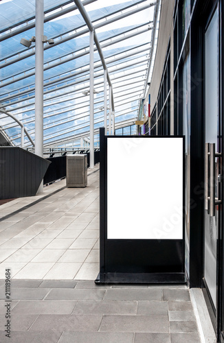 Blank white outdoor advertising stand mock up template. Clear street signage board placed outside store in modern building. Urban city shopping center environment.