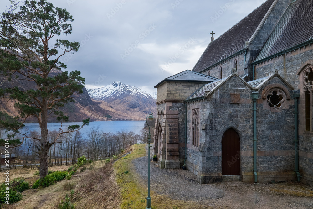 Glenfinnan Church with Loch Shiel Lake view and snowy Highlands mountain peaks