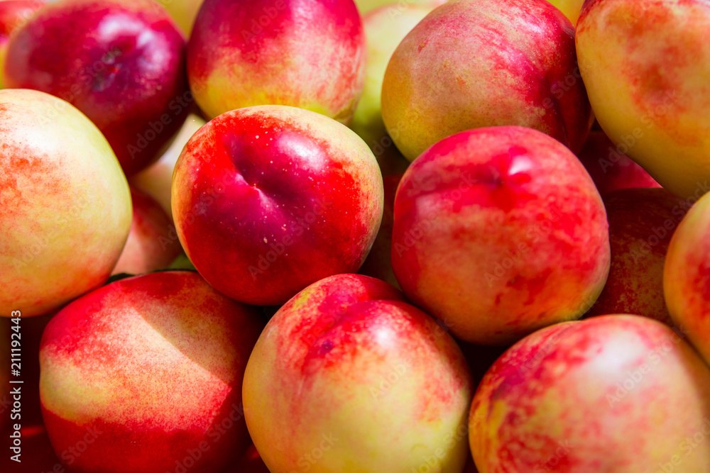 Fresh bright nectarines background in the market Fresh bright nectarines background in the market