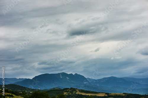 Mountain forest landscape covered by green pine under morning sky with clouds  Country Side