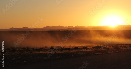 Dust from the road during the sunset on the savannah